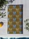 Set of four golden cloth napkins featuring alternating powder blue and metallic gold ravens in flight, sized 18x18 inches.